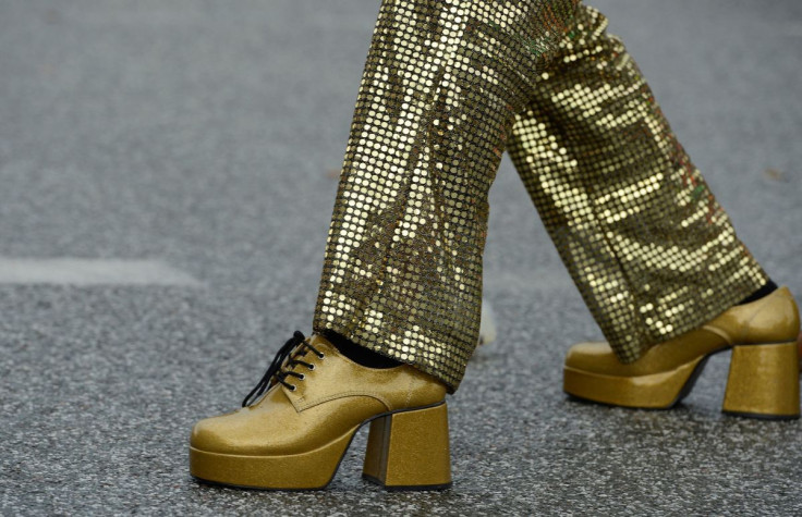 A man wearing 1970s-themed golden shoes and clothes dances on the street during the Schlagermove festival in Hamburg July 7, 2012. 