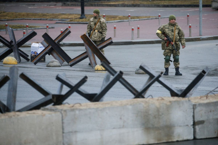 Members of the Territorial Defence Force stand guard at a check point, as Russia's invasion of Ukraine continues, at the Independence Square in central Kyiv, Ukraine, March 3, 2022. 