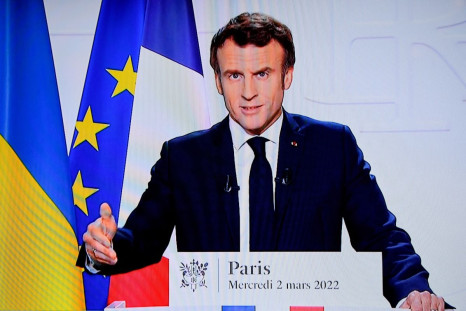 French President Emmanuel Macron appears on a screen as he delivers a speech on the Russian invasion of Ukraine, in Paris, France, March 2, 2022. 