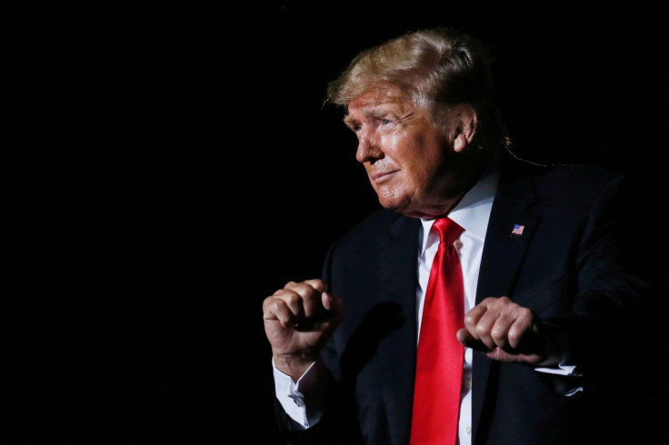 Former U.S. President Donald Trump reacts after his speech during a rally at the Iowa States Fairgrounds in Des Moines, Iowa, U.S., October 9, 2021. 