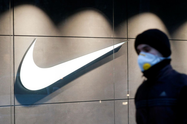 A man wearing a protective face mask amid the outbreak of the coronavirus disease (COVID-19) walks past a Nike brand store in central Kyiv, Ukraine December 10, 2020. 