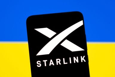 Starlink logo is seen on a smartphone in front of displayed Ukrainian flag in this illustration taken February 27, 2022. 
