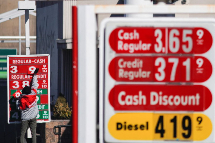 A worker changes the numbers of a price at the Lukoil fuel station, after local officials voted to suspend the business license of local Lukoil gas stations following the Russian's invasion of Ukraine, in Newark, New Jersey, U.S., March 3, 2022. 