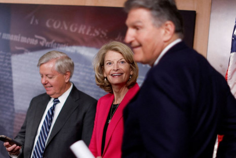 U.S. Senator Lindsey Graham (R-SC) and Senator Lisa Murkowski (R-AK) chide Senator Joe Manchin (D-WV) for his phone ringing at the start of a news conference to introduce a bill to ban Russian energy imports, at the U.S. Capitol in Washington, U.S., March