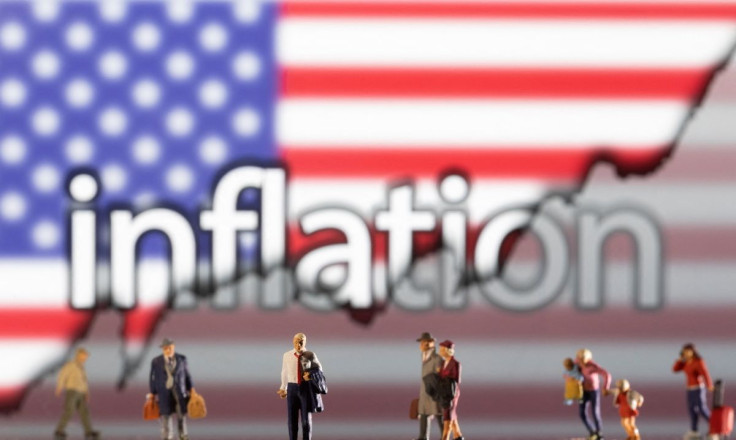 Small figurines are seen in front of displayed word "Inflation", U.S. flag and rising stock graph in this illustration taken February 11, 2022. 