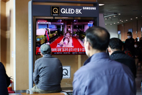 People watch a TV broadcasting file footage of a news report on North Korea firing a ballistic missile off its east coast, in Seoul, South Korea, October 19, 2021. 