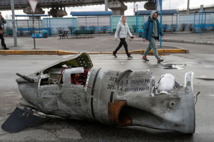 People walk past the remains of a missile at a bus terminal, as Russia's invasion of Ukraine continues, in Kyiv, Ukraine March 4, 2022.