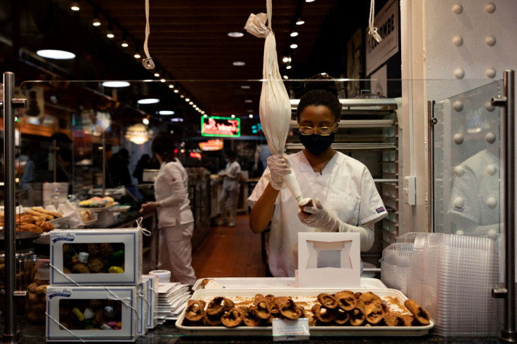A worker fills a cannoli at a bakery at Reading Terminal Market after the inflation rate hit a 40-year high in January, in Philadelphia, Pennsylvania, U.S. February 19, 2022.