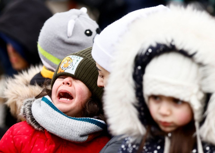 A mother tries to comfort her child as he cries after fleeing the Russian invasion of Ukraine, at the border checkpoint in Medyka, Poland, March 4, 2022.