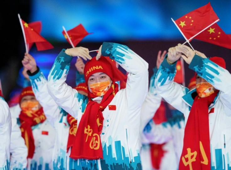Chinese Paralympians wave their national flag as they enter Beijing's "Bird's Nest" stadium on Friday