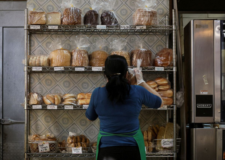 A baker stocks shelfs with bread at the Eastern Market in Washington, U.S., February 11, 2022. 
