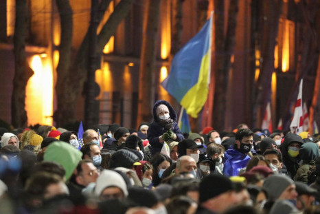 Demonstrators gather in front of a screen to watch the broadcast of the live speech of Ukraine's President Volodymyr Zelenskiy during an anti-war rally in Tbilisi, Georgia, March 4, 2022. 