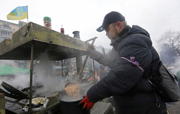 A man prepares food for local residents and members of the Territorial Defence Forces at a field kitchen in Kyiv, Ukraine March 3, 2022.