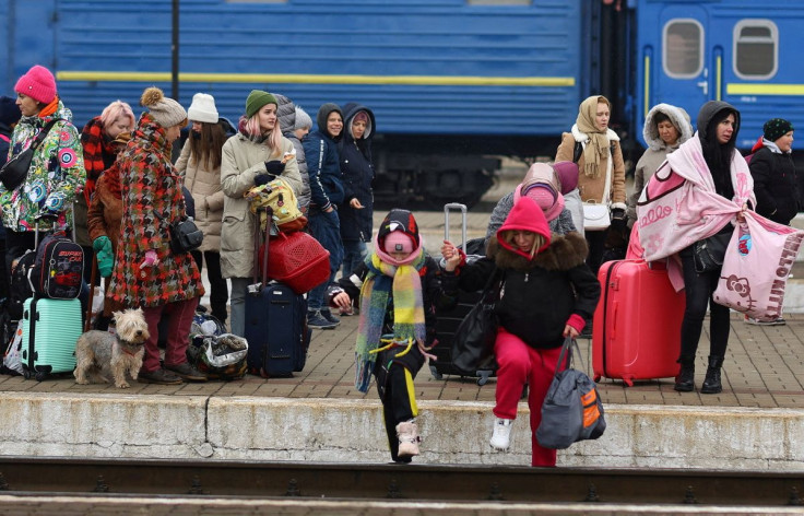 Refugees crossing the rail tracks as they try to reach trains to Poland following Russiaâs invasion of Ukraine at the main train station in Lviv, Ukraine, March 4, 2022.