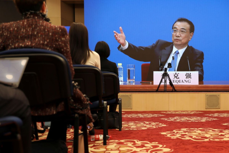 Chinese Premier Li Keqiang is seen on a screen during a news conference held via video link, following the closing session of the National People's Congress (NPC) in Beijing, China March 11, 2021.