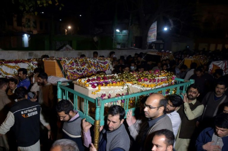 Mourners carry the coffins of victims killed in the attack on a Peshawar mosque