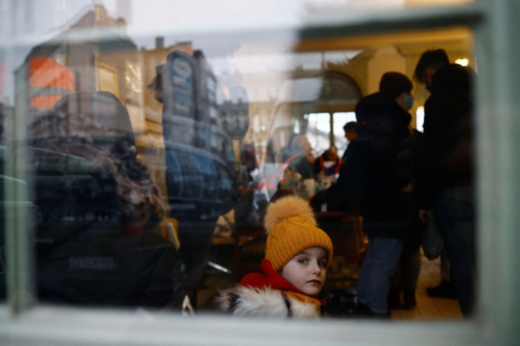 A child looks out of a window in a temporary accommodation for refugees, after fleeing the Russian invasion of Ukraine, at the train station in Przemysl, Poland, March 4, 2022. Picture taken March 4, 2022. Picture taken through a glass window. 
