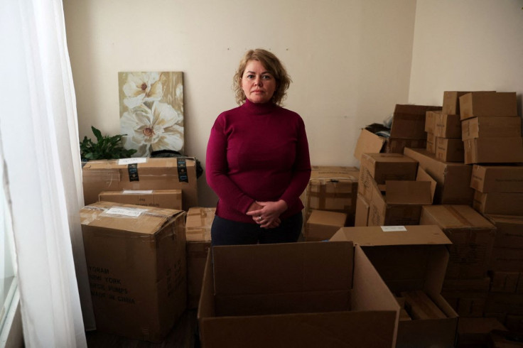 Inga Sokolnikova stands for a photograph in a room full of donations for people suffering from Russia's invasion of Ukraine at a salon in the Brighton Beach neighborhood in the Brooklyn borough of New York City, U.S., March 4, 2022. Picture taken March 4,
