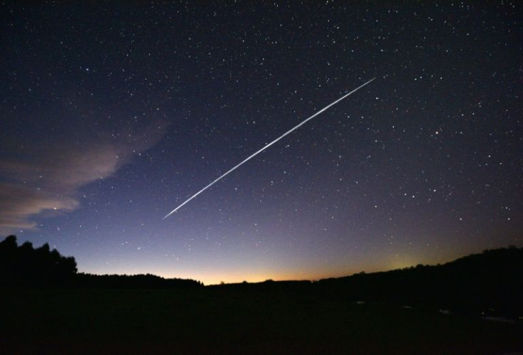 This long-exposure image captured on February 7, 2021, shows a trail of a group of SpaceX's Starlink satellites passing over Uruguay