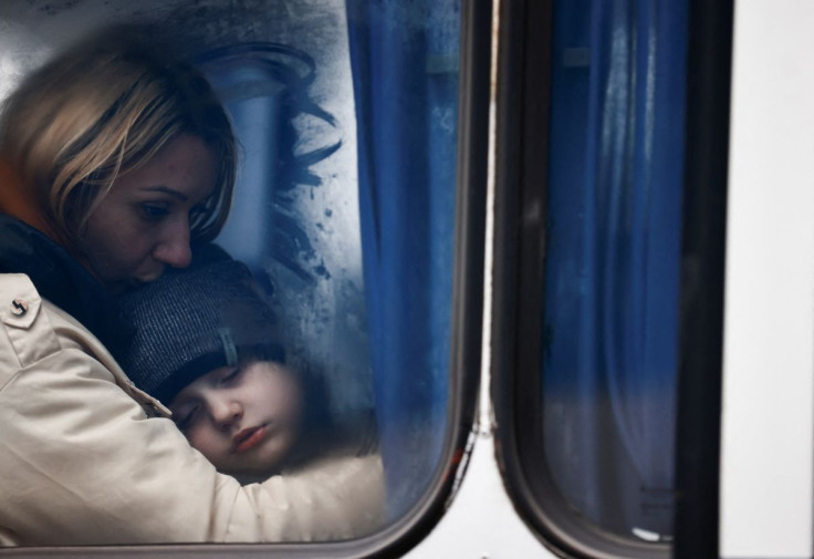 A woman and her son are seen through a bus window as they arrive at a temporary accommodation centre, after fleeing Russian invasion of Ukraine, in Korczowa, Poland, March 5, 2022.
