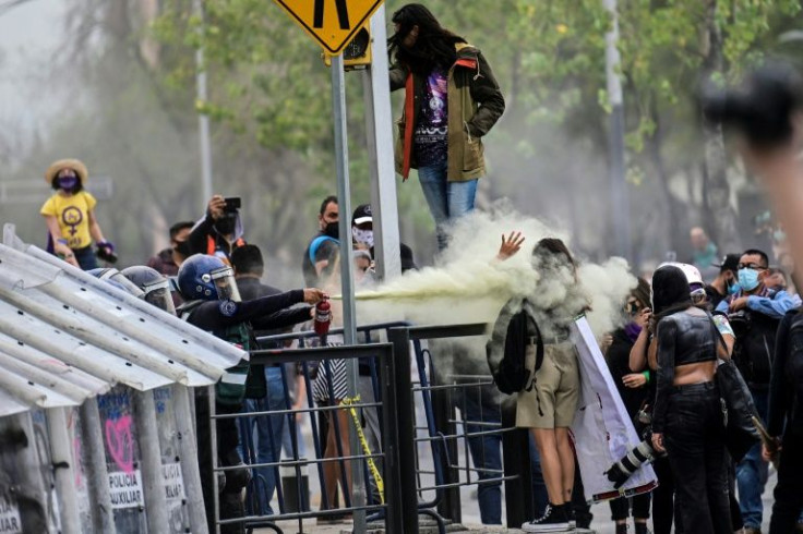 While the women police say they empathize with the protesters, some demonstrators accuse them of acting 'like a male oppressor'