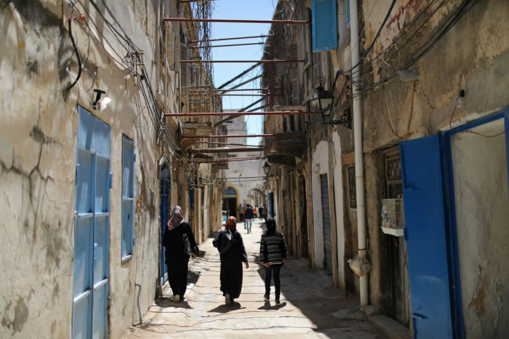 Libyan people walk at the old city of Tripoli, Libya April 13,2019. Picture taken April 13, 2019. 