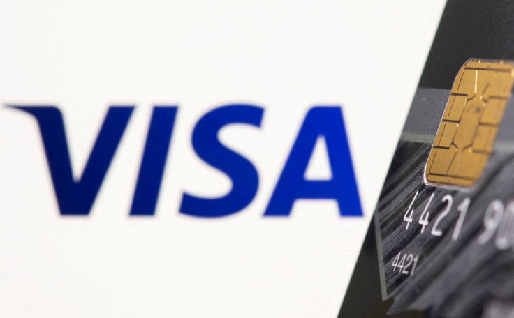 Credit card is seen in front of displayed Visa logo in this illustration taken July 15, 2021. 