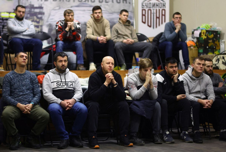 Volunteers for territorial defense listen to their instructor during their training at the warrior house, following the Russia's invasion of Ukraine, in Lviv, Ukraine, March 6, 2022.