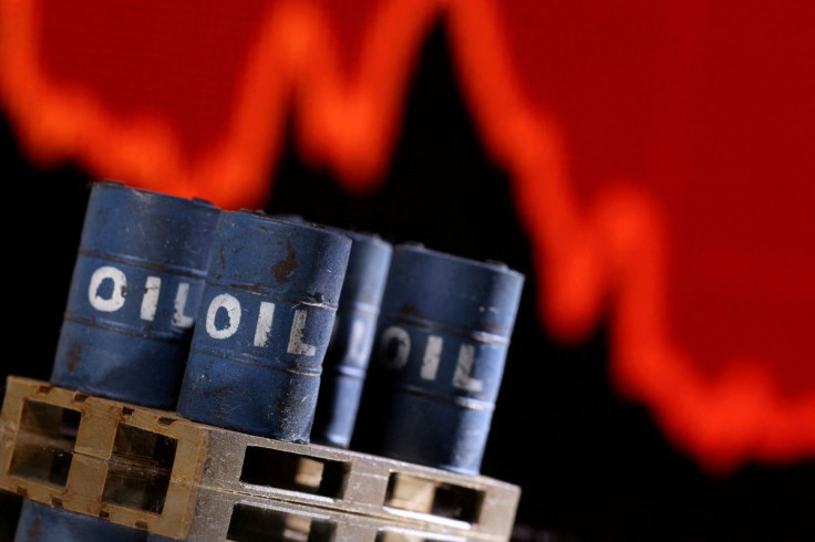 A model of 3D-printed oil barrels is seen in front of displayed stock graph in this illustration taken, December 1, 2021. 