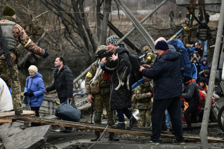Ukrainians have been crossing what remains of a destroyed bridge to reach Kyiv