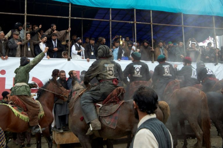 The Kandahar team line up in front of the VIP stand after winning the Afghanistan buzkashi championship in Kabul