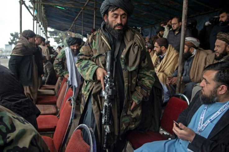 A Taliban fighter makes his way through the VIP stand during the buzkashi final in Kabul