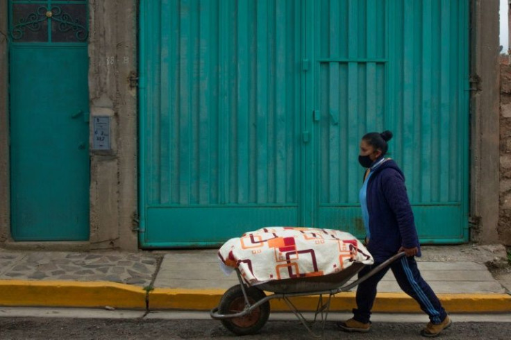 Yolanda Chambi uses a wheelbarrow to cart around the food she tries to sell by the roadside
