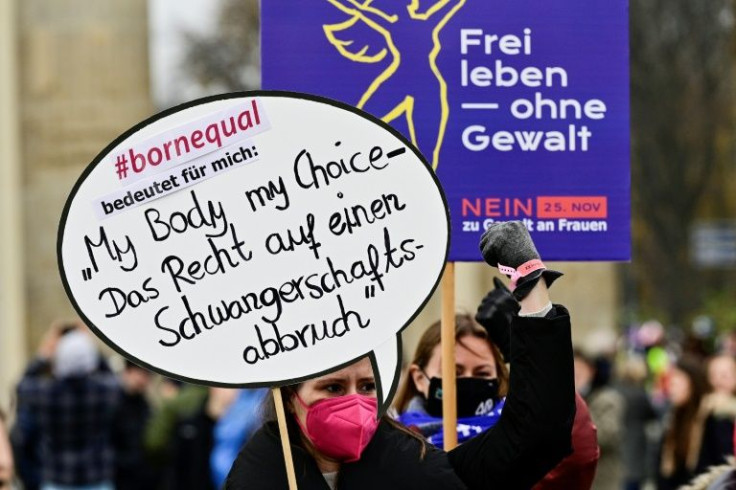 A protester's sign reads "My Body my choice- the right to abortion" during a November demonstration against violence against women in Berlin
