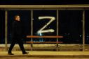 a-man-walks-past-the-symbol-z-painted
