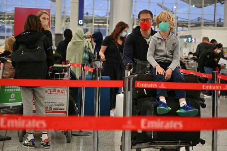 Expat familes line up at the check-in counter as they prepare to depart Hong Kong, where Covid restrictions have clamped down in 2022 to flatten an Omicron-fuelled wave