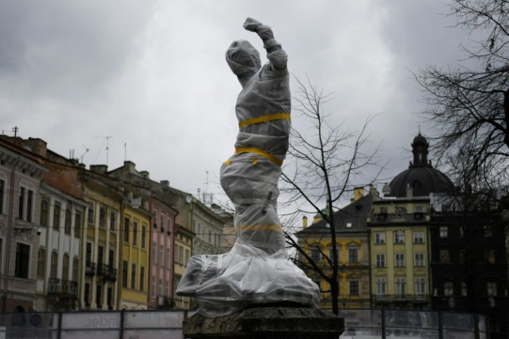 Statues wrapped in foam and fireproof material can be seen all around the historic city of Lviv