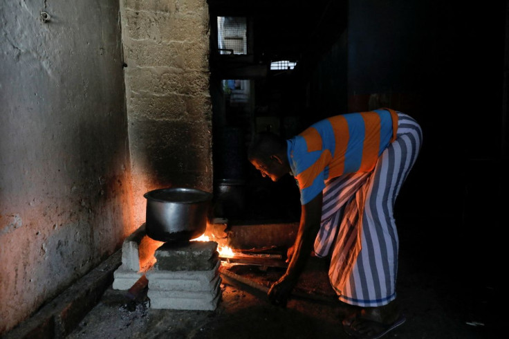 A staff uses a traditional Sri Lankan wooden stove to cook at a hotel during a power outage after two main gas companies have suspended supplies as the country grapples with a severe foreign currency shortage, in Colombo, Sri Lanka March 7, 2022.