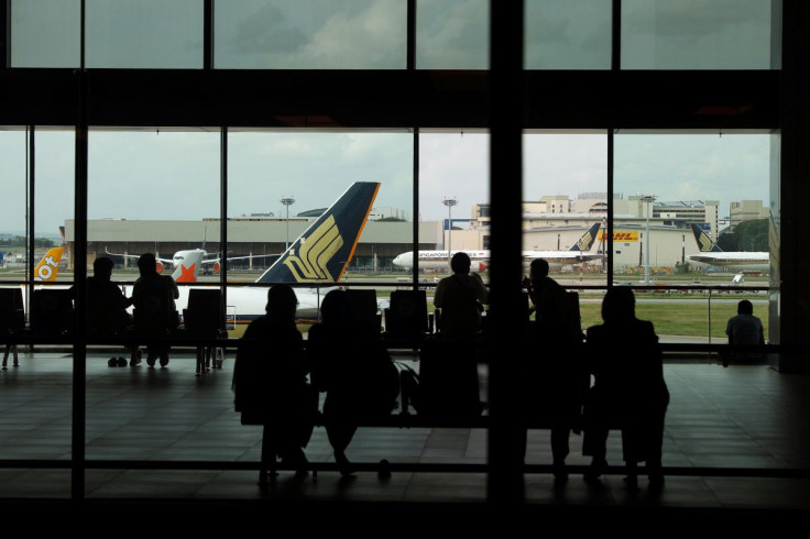 People look at a Singapore Airlines plane, amid the spread of the coronavirus disease (COVID-19), at a viewing gallery of the Changi Airport in Singapore October 12, 2020.
