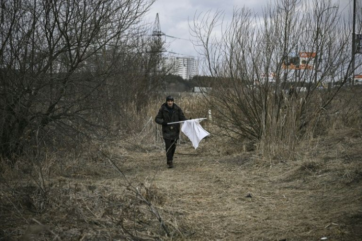 Some residents fleeing Irpin wave white flags to avoid being hit by Russian snipers hiding in some buildings