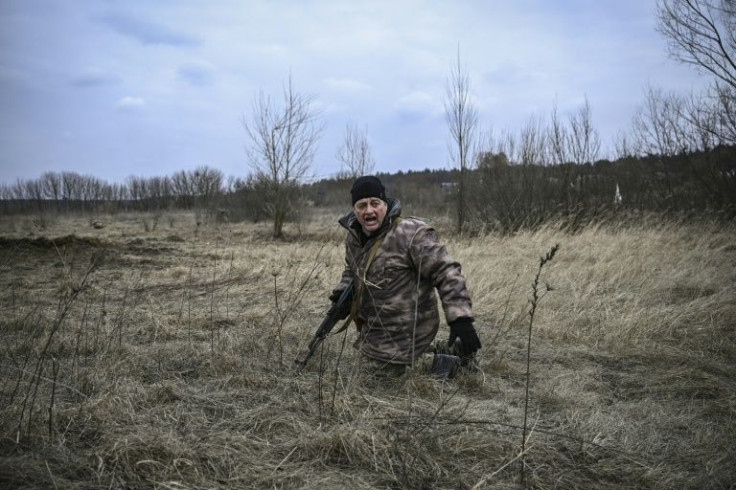 Ukrainian serviceman at the edge of Kyiv provide cover for civilians fleeing the incessant Russian shelling attacks