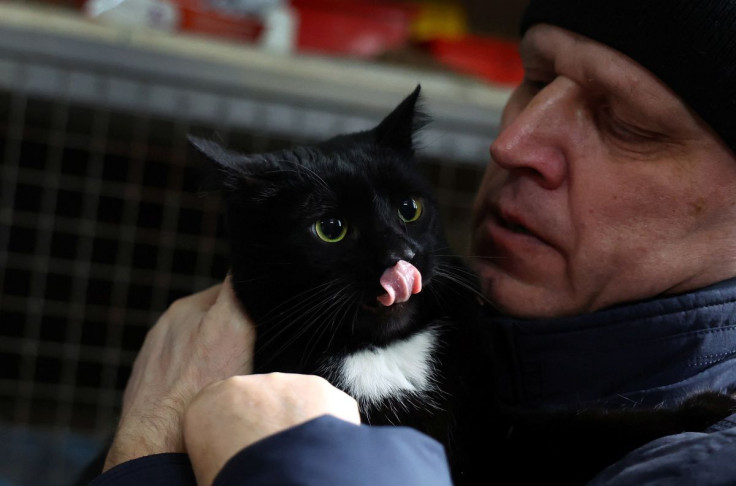 Volodymyr Horobets who fled the Russian invasion from Mariupol holds his cat "Charly" before handing him over to Latvian pet caretaker Rama Kreica after they met at an animal shelter in Lviv, Ukraine, March 7, 2022. Kreica and her crew of volunteers plan