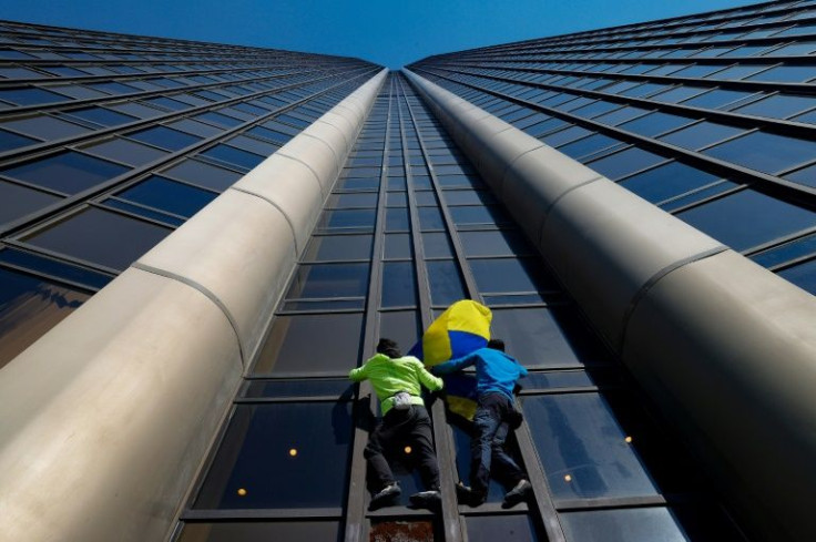 The urban climber draped a Ukrainian flag on the building