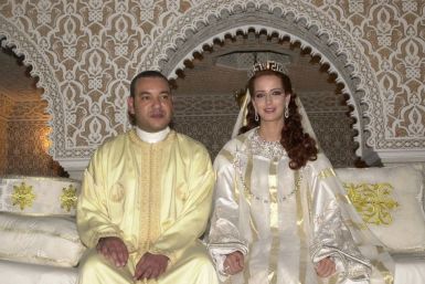 Morocco&#039;s King Mohammed VI poses with his bride unveiled Salma Bennani for an official photograph.