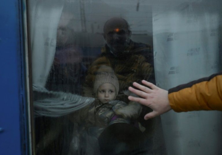 A father says goodbye to his daughter on an evacuation train leaving Odessa -- feared to be the next target of Russia's offensive in the south