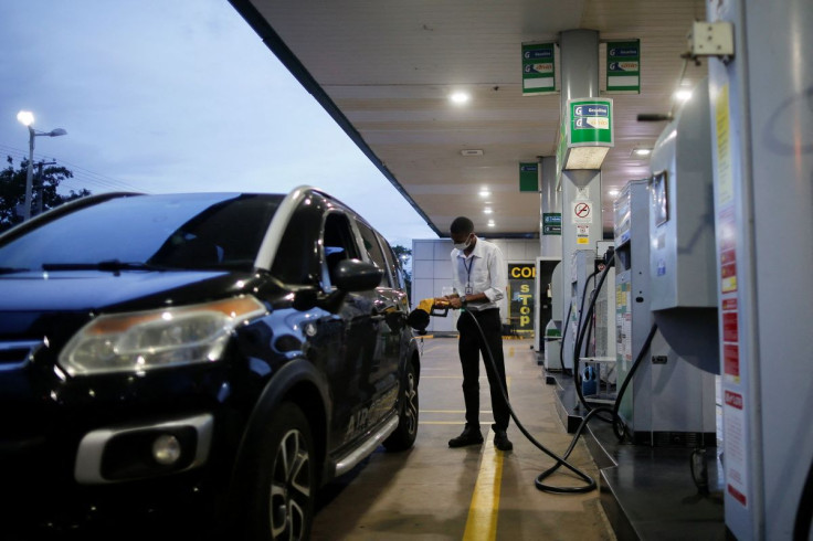 A worker uses a petrol pump at a Brazilian oil company Petrobras gas station in Brasilia, Brazil March 7, 2022. 