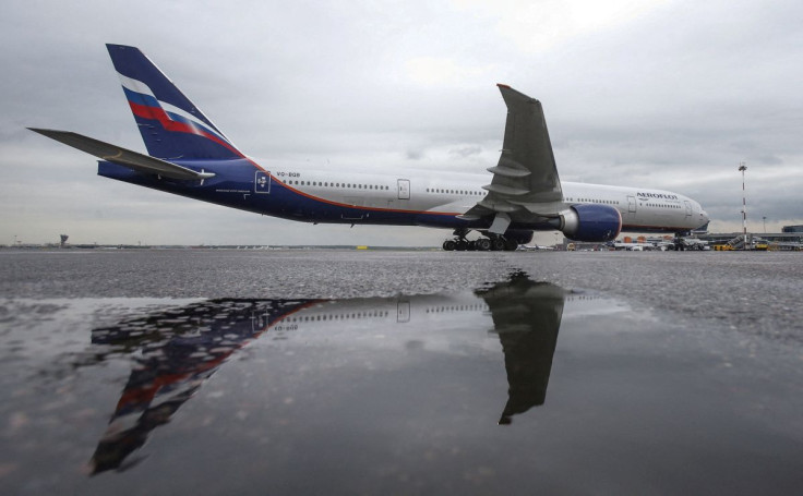 An Aeroflot Boeing 777-300ER aircraft is reflected in a puddle at Sheremetyevo International Airport outside Moscow, Russia, July 7, 2015. 