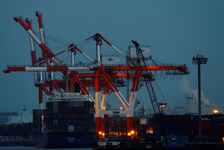 A cargo ship and containers are seen at an industrial port in Tokyo, Japan, February 15, 2022. 