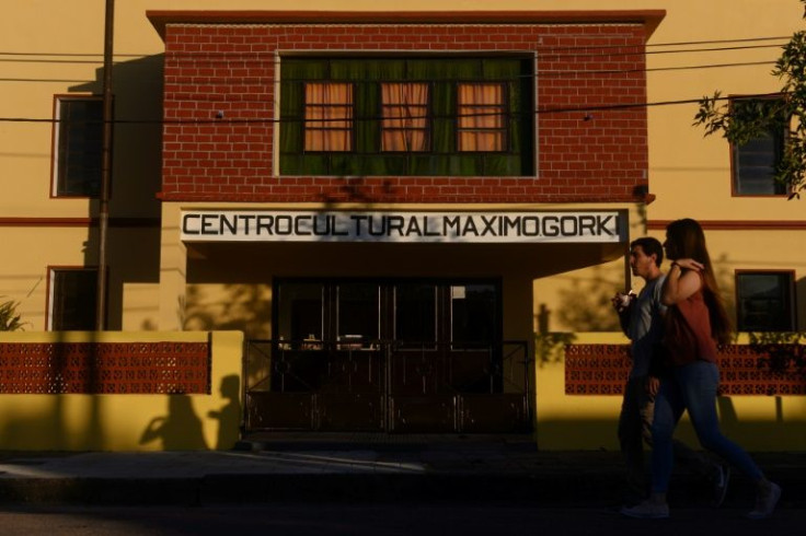 People walk past the Maximo Gorki Cultural Centre in San Javier, Uruguay on March 2, 2022