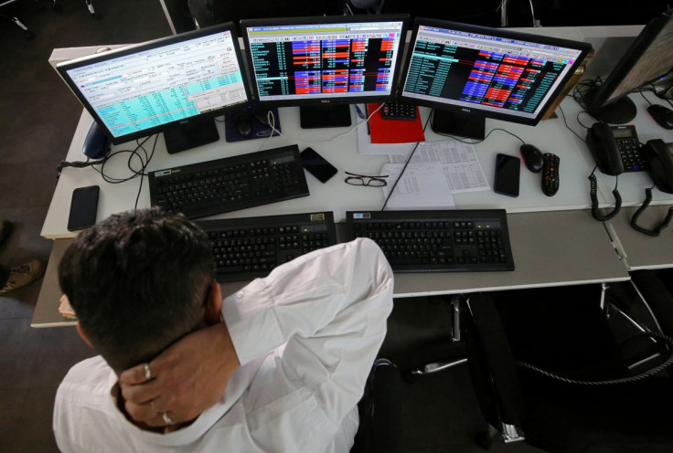 A broker reacts while trading at his computer terminal at a stock brokerage firm in Mumbai, India, December 11, 2018. 